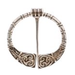 Alexander Ritchie- A Scottish silver kilt pin, circular form with embossed Celtic decoration,