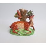 A Staffordshire Spill Holder with a Model of a recumbent Stag and a Fox sitting on a branch