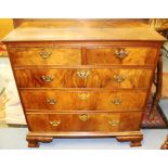 A George I walnut chest of drawers, circa 1720, projected moulded top, fitted with two short over