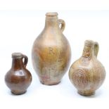 A 17th Century style stoneware wine flask, plain body incised R; a saltglazed wine flask, the neck