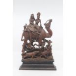 An Indian carved hardwood figure group of a hunting party, 19th Century, modelled as a dignitary and