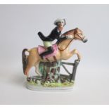 A Very Rare Staffordshire Figure of Tam O’Shanter, astride his horse Meg, wearing a Tri corn hat
