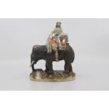 A Staffordshire figure group of a Mahout with slain tiger aboard an elephant, circa 1860, painted in