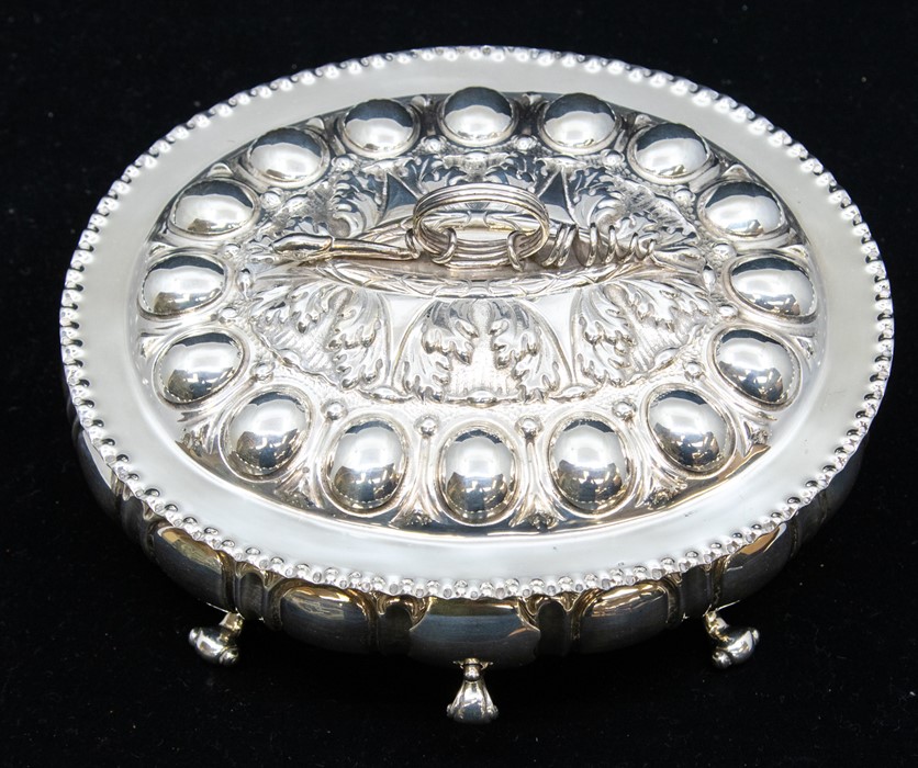 A late Victorian Renaissance Revival silver box and cover, with lobed body on four scroll feet,
