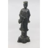 A Chinese carved dark green mottled soapstone figure of Guanyin, late Qing/Republic period, modelled