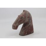 A Chinese painted pottery funerary figure of a horses head, Han Dynasty, of stylised form with mouth