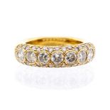 A diamond and 18ct gold ring, comprising a domed band pave set with a central rows of collet set