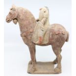 A Chinese pottery figure of a horse and rider, Tang Dynasty, approx 15cm high x 19cm long (