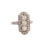 An Art Deco style diamond and platinum dress ring, the lozenge shaped mount set to the centre with