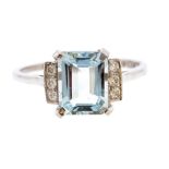 An aquamarine and diamond platinum dress ring, the claw set emerald cut aqua weighting approx. 2.