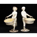 A pair of Modern Continental style figural silver table salts cast as fruit sellers in 18th