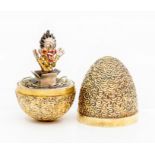 Stuart Devlin- a silver gilt surprise 'clown' egg, silver textured form opening to reveal a wobbling