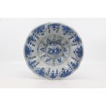 A German faience dish or 'buckelplatter', 18th Century, of lobed circular form and decorated with