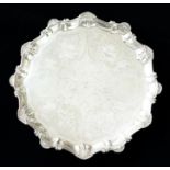 A George III silver salver, pie crust rim with shell points, the centre engraved with floral