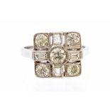 A diamond and platinum dress ring, the cushion shaped mount set to the centre with a round brilliant