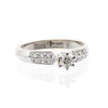 A diamond and 18ct white gold solitaire ring the central claw set diamond weighing approx. 0.20ct,