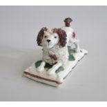 An English Porcelain  model of a ‘Lion clipped’ Bi coloured Poodle, laying with his hindquarters