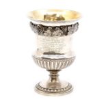 A George III Regency period silver pedestal campana shaped wine goblet, the body with cast