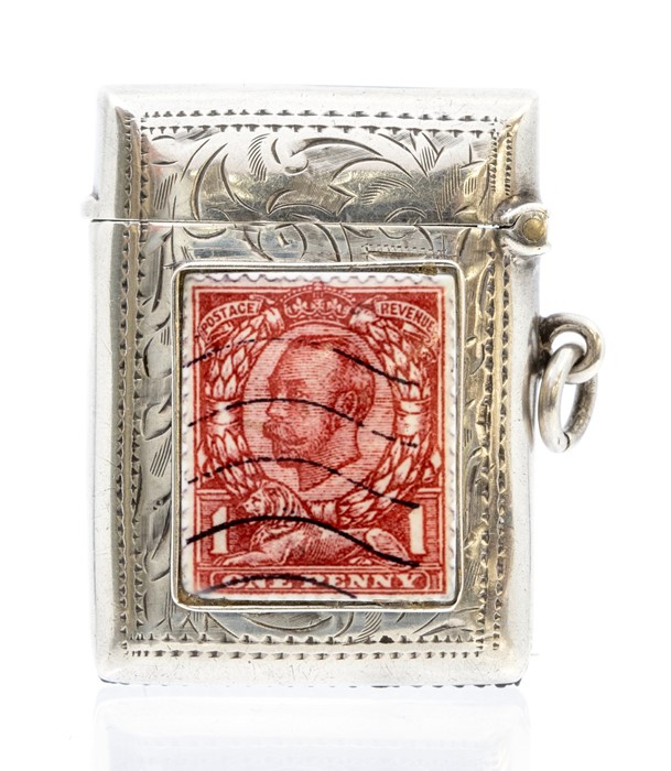 A George V silver vesta case, foliate engraved case with enamel one penny red enamel stamp to the