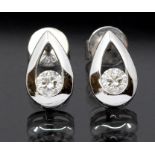 A pair of diamond and 18ct white gold earrings, comprising pear shaped open forms, each set with a