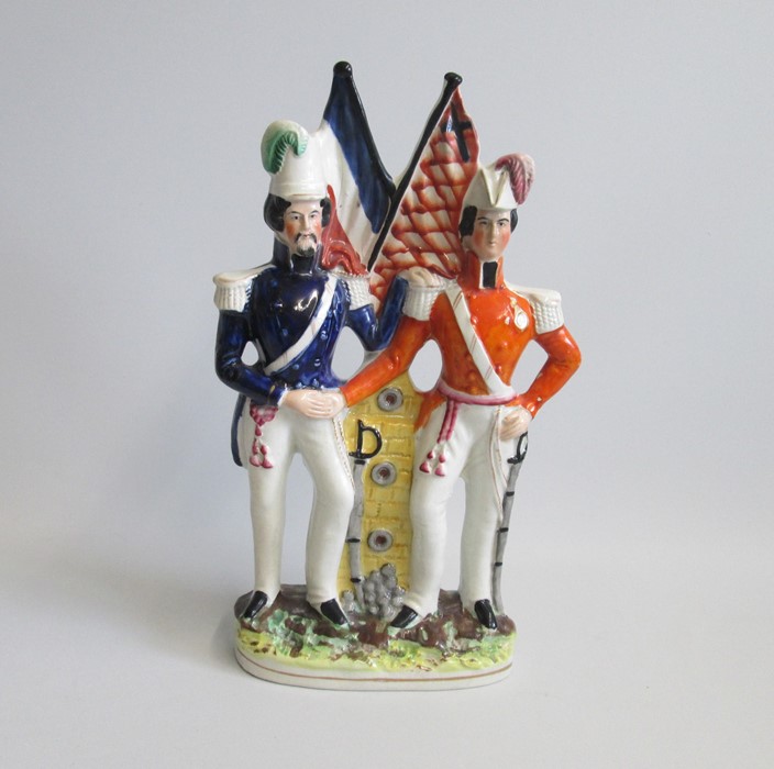 A Staffordshire Crimean War Figure of Prince Albert and Napoleon Bonaparte 3rd Standing beside Flags