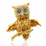A vintage18ct gold owl brooch, cabochon emerald set eyes with diamond set surrounds, total diamond