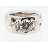 A diamond three stone 18ct white gold ring, comprising a central set round brilliant cut diamond