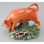An early early nineteenth century Staffordshire bull baiting figure, c.1820-30. It depicts a dog