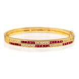 An 18k yellow gold diamond and ruby hinged bracelet, the front with two rows, each channel set