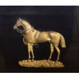 A late 19th Century cast ormolu profile of saddled up horse, in a glazed cushioned rosewood frame.