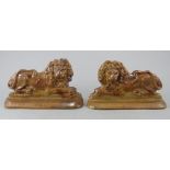 Two early nineteenth century Staffordshire brown salt glaze stoneware named and dated lions, c.1840.