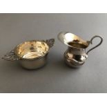 A George V silver miniature porringer with flat section pierced handles, London 1912 and a miniature