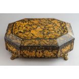 A Regency work casket, circa 1825, of sarcophagus form, black japanned with gilt foliage decoration,