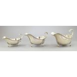 A set of three silver graduated sauce boats, gadroon borders, hoof feet, maker Barker Ellis & Co,