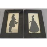 A pair of 19th Century full length profile silhouette portrait miniatures, lady holding a flower and