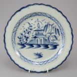 An early nineteenth century pearlware shell-edge hand-painted blue and white plate, c.1800. It is