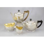 A late Victorian composite silver four piece oval stop-fluted silver tea set, London 1886 and