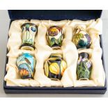 A set of six Moorcroft miniature vases, of various designs, height typically 5cm, in a fitted