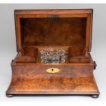 A mid Victorian burr walnut tea caddy, circa 1850, of sarcophagus form, hinged cover opening to a