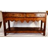 A George III oak open dresser base, circa 1800, rectangular top fitted with two frieze drawers,