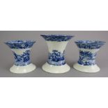 A group of early nineteenth century blue and white transfer-printed garniture of vases, c.1820. They