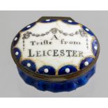 A Bilston enamel oval patch box, circa 1780, the cover with motto A Trifle from Leicester,