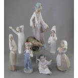 A group of Ladro figures and two Nao. Comprising: a female figure with a tambourine, a seated angel,