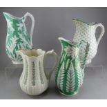 A group of early nineteenth century green stoneware relief moulded jugs, c.1830-50. To include: a