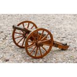 A desk model of a Napoleonic Wars type artillery cannon with two separate ramrods, wheel stopper