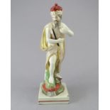 An early nineteenth century Staffordshire pearlware figure of Neptune on a square base, c.1810-20.