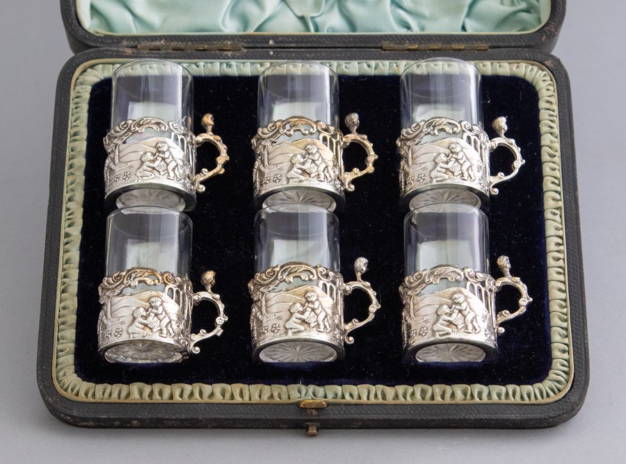 A cased set of six late Victorian silver miniature demitasse, pierced cherub scenes, clear glass