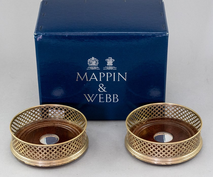 A boxed pair of Mappin & Webb silver wine coasters, pierced sides, turned wooden inserts with