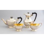 A George V silver four piece silver tea set, baluster shapes, gilt interiors, maker Frank Cobb &