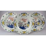 A set of three eighteenth century tinglazed earthenware delft plates, c.1750-80. Each is decorated